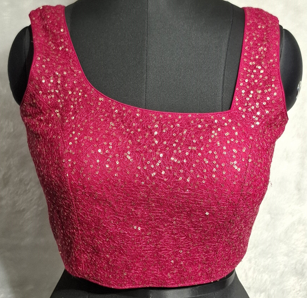 Hot pink net blouse with golden sequins and asymmetrical neckline