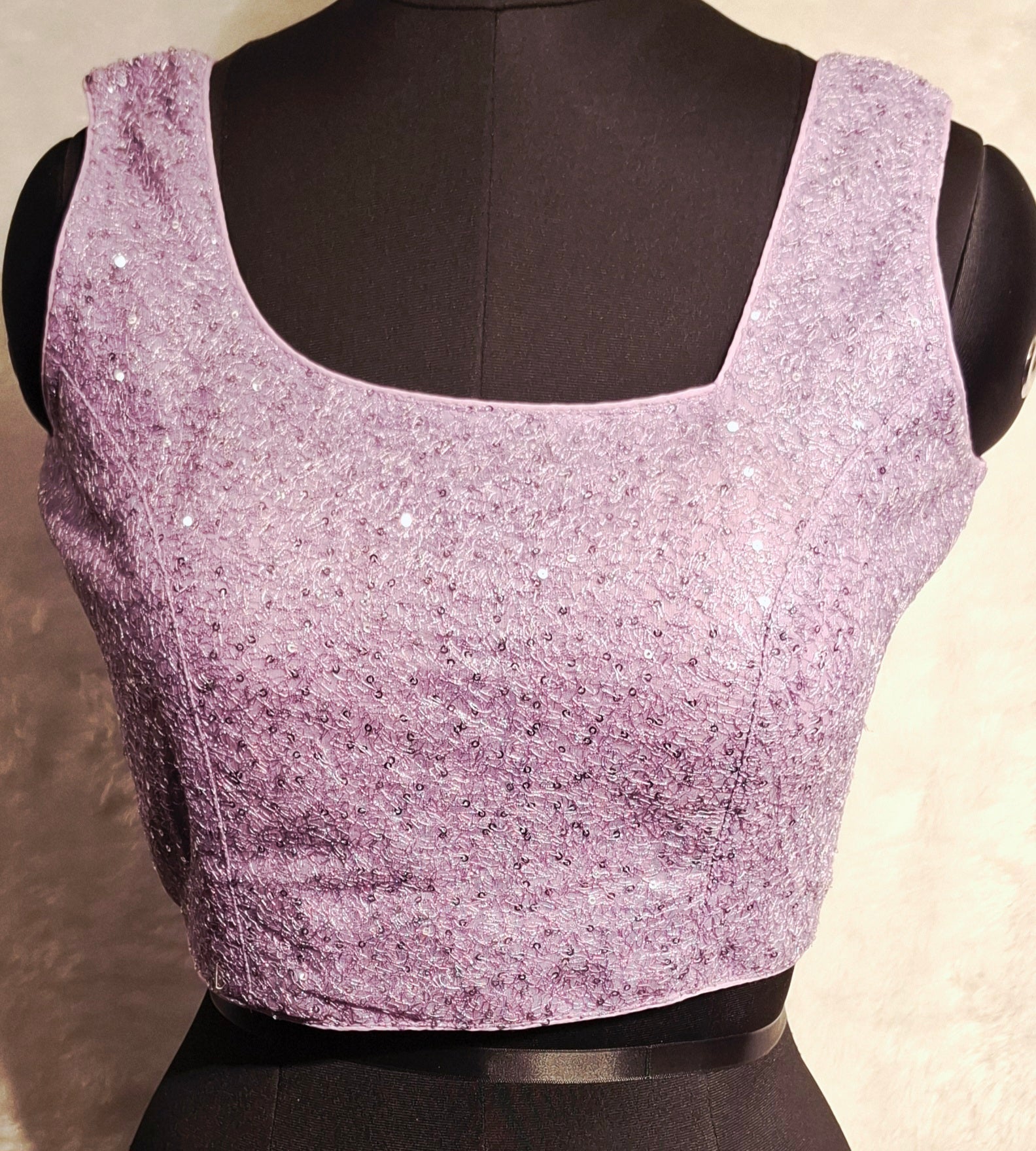 Lilac readymade blouse with all-over silver sequins and asymmetrical neckline.