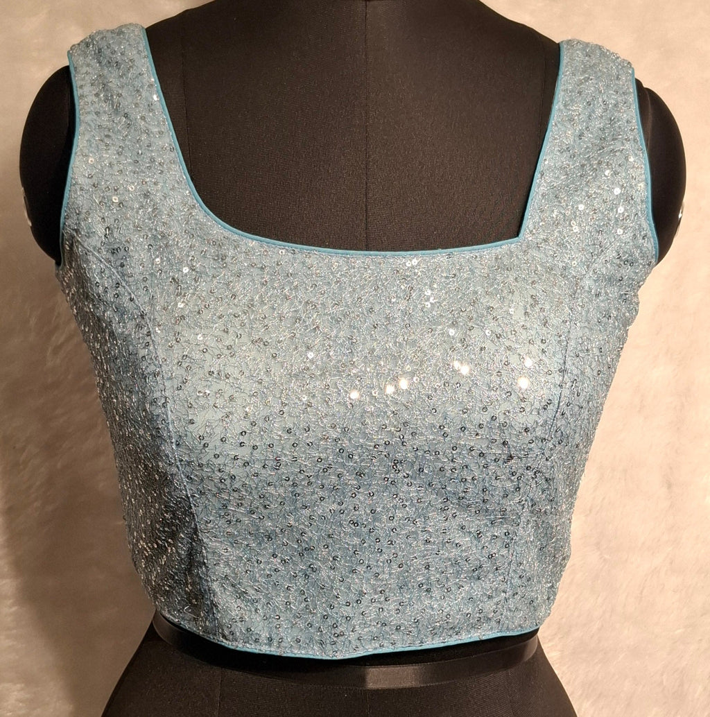 Powder Blue blouse with all-over silver sequins and asymmetrical neckline