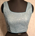 Powder Blue blouse with all-over silver sequins and asymmetrical neckline