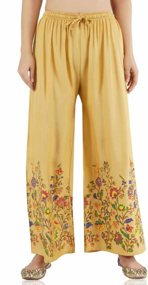 Woman wearing Mominos Fashion golden palazzo pants with floral print design