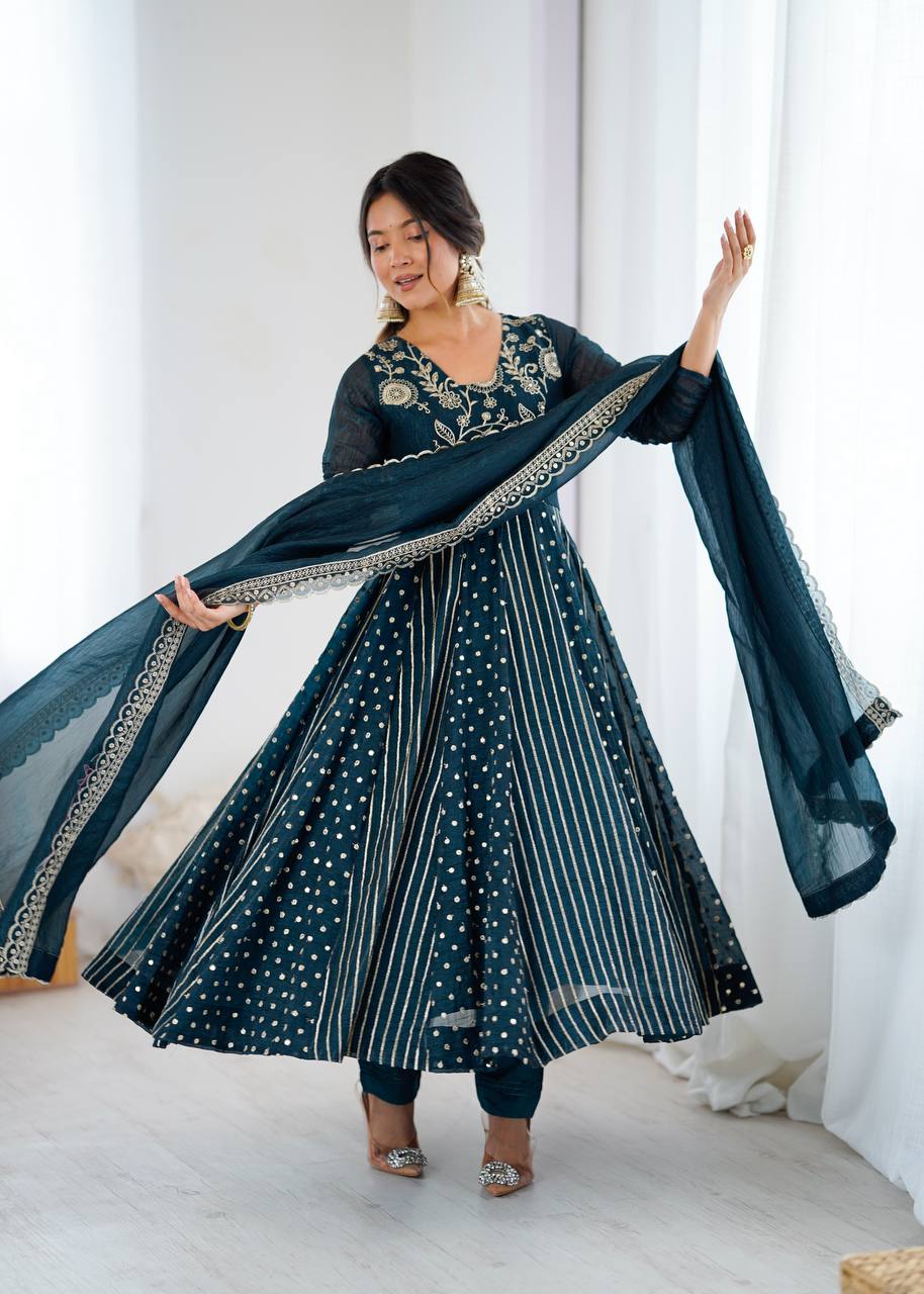 Elegant teal crunchy silk Anarkali gown with gold embroidery and full flare.