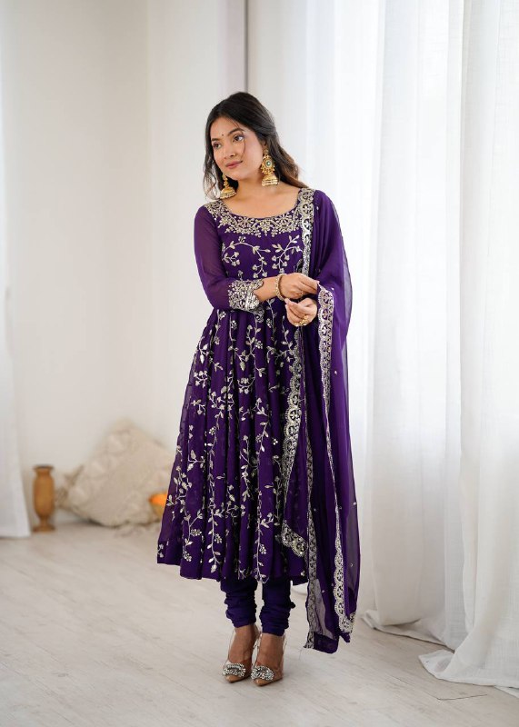 A beautiful violet faux georgette Anarkali gown with silver floral embroidery and wide flair.