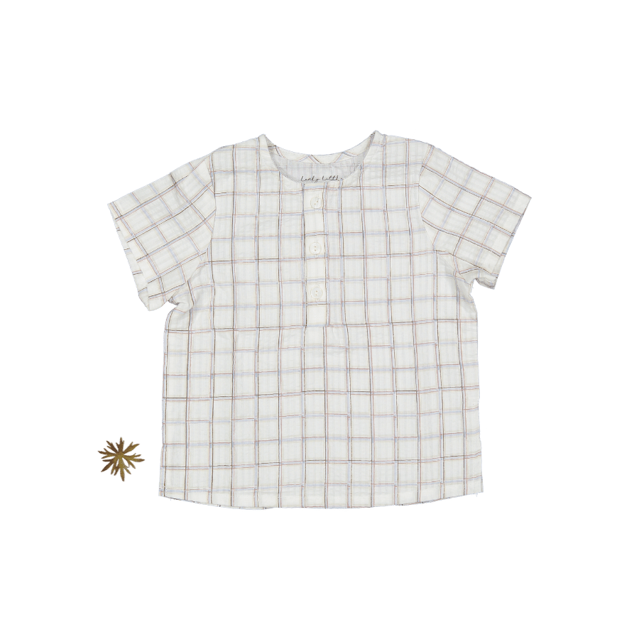 Baby woven tunic in a white and blue-brown sketch grid pattern with a three-button front closure.