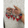 Silver-tone designer bangle with red pearls and hanging mirror latkan accents.