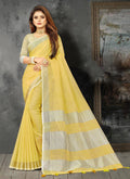 Elegant yellow woven linen saree with contrast zari border and decorative tassels