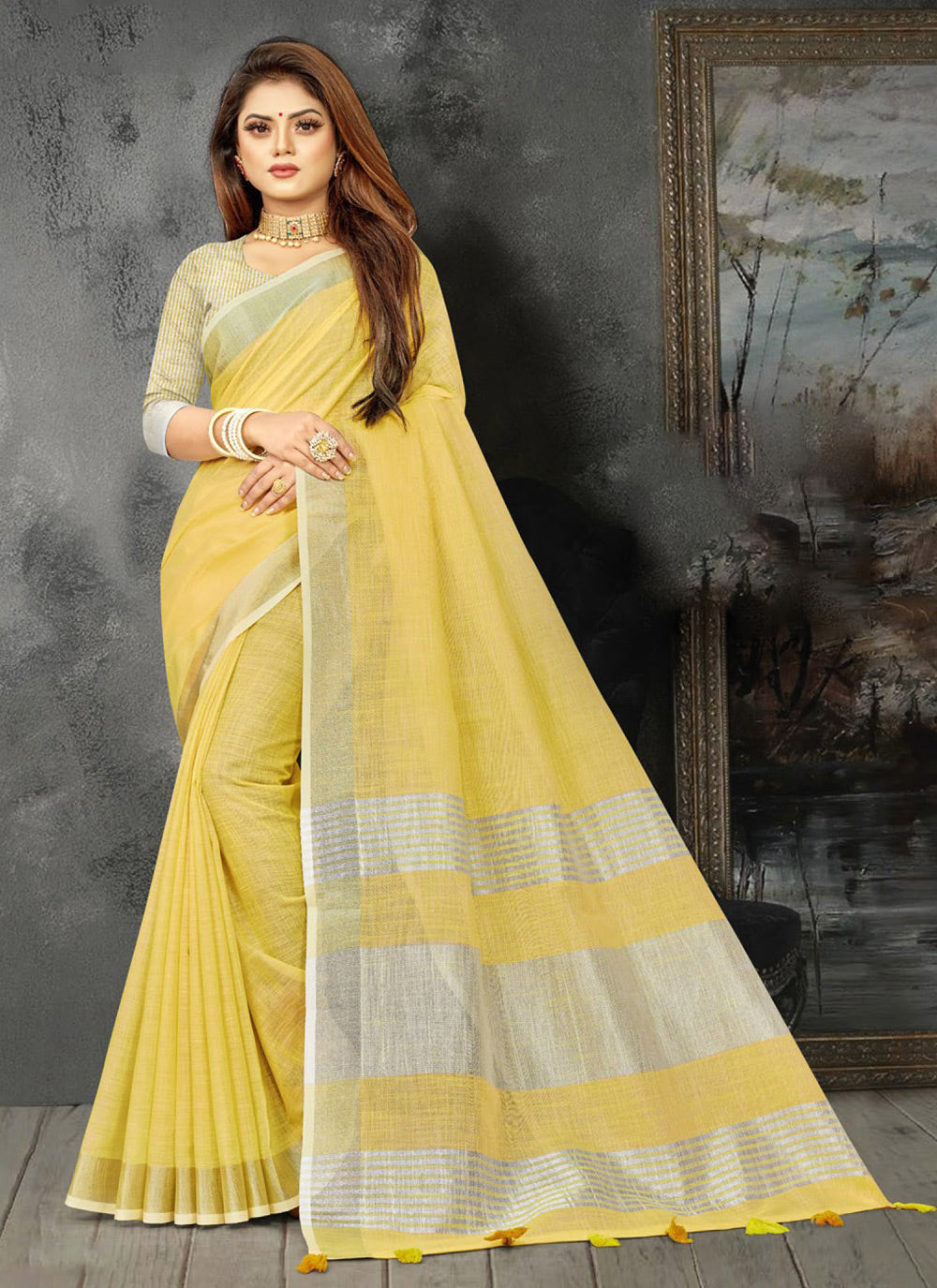 Elegant yellow woven linen saree with contrast zari border and decorative tassels