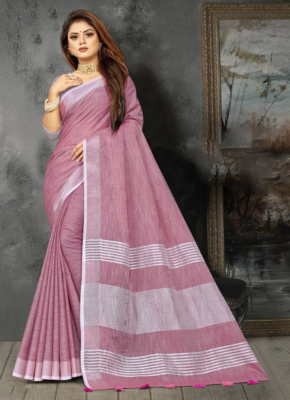 Elegant mauve linen saree with gold zari border and decorative pallu tassels