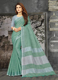 Sea green woven linen saree with an elegant zari border and decorative tassels.