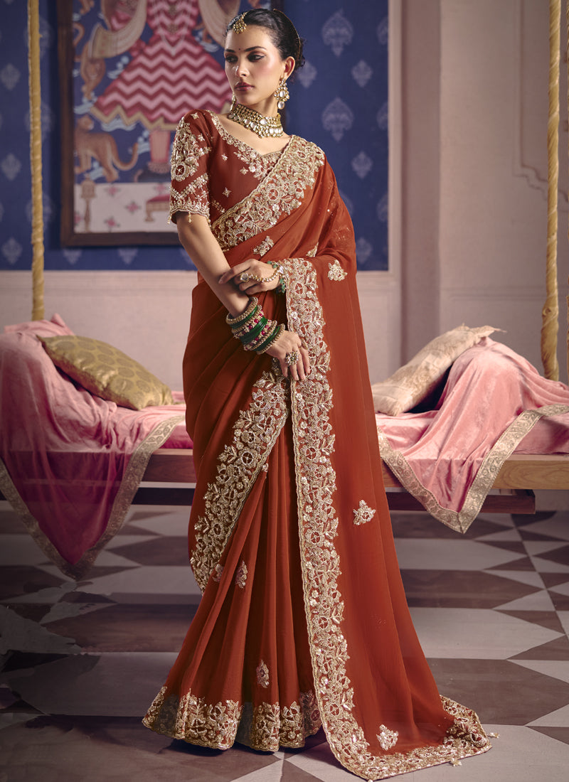 Elegant red silk saree with intricate embroidery and heavy lace border for weddings