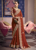 Elegant red silk saree with intricate embroidery and heavy lace border for weddings