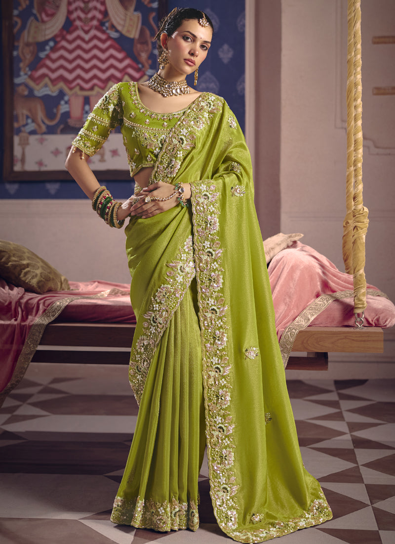 Vibrant parrot_green silk saree with heavy lace border detail for weddings.