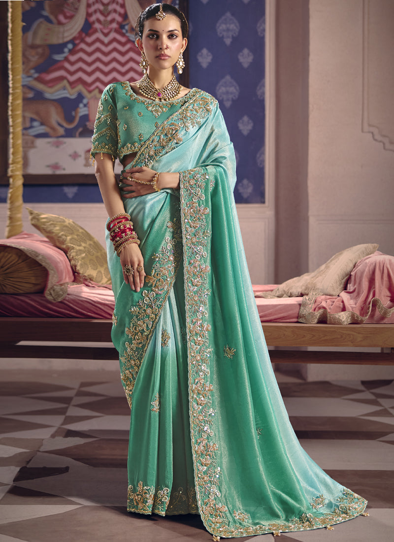 Turquoise silk embroidered saree with decorative heavy lace border