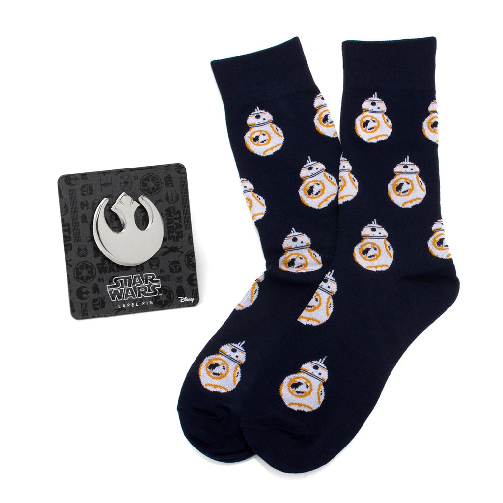 A gift set containing navy blue crew socks with a repeating pattern of BB-8 and a silver Star Wars Rebel Alliance lapel pin.