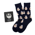 A gift set containing navy blue crew socks with a repeating pattern of BB-8 and a silver Star Wars Rebel Alliance lapel pin.