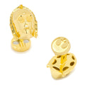 A pair of gold-tone 3D C-3PO head shaped cufflinks on a white background.