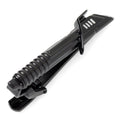 Close up of a black and silver Darksaber tie clip showing the textured handle and blade details.