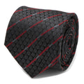 Close-up view of a black silk necktie featuring a repeating Darth Vader helmet pattern and diagonal red lightsaber stripes.