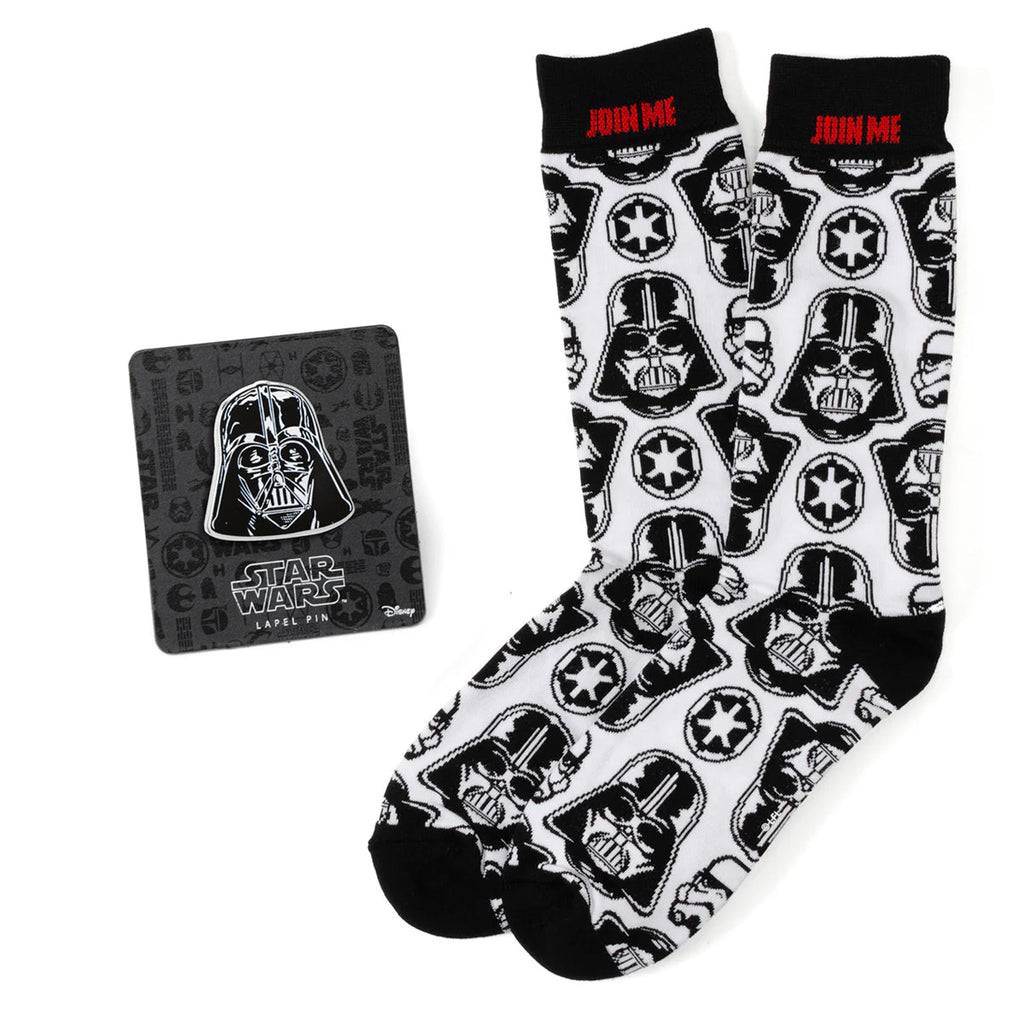 A pair of white crew socks with a repeating Darth Vader helmet pattern and a matching Darth Vader metal lapel pin.
