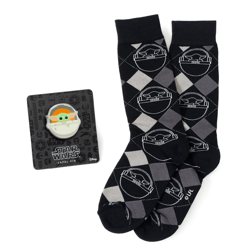 Star Wars Grogu charcoal gray argyle crew socks displayed next to a Grogu lapel pin on its backing card.