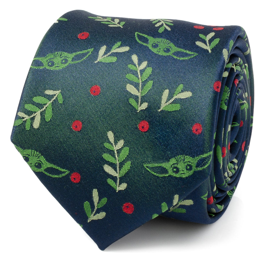 Close up of a navy blue necktie with a repeating pattern of Grogu from The Mandalorian, green holly leaves, and red berries.