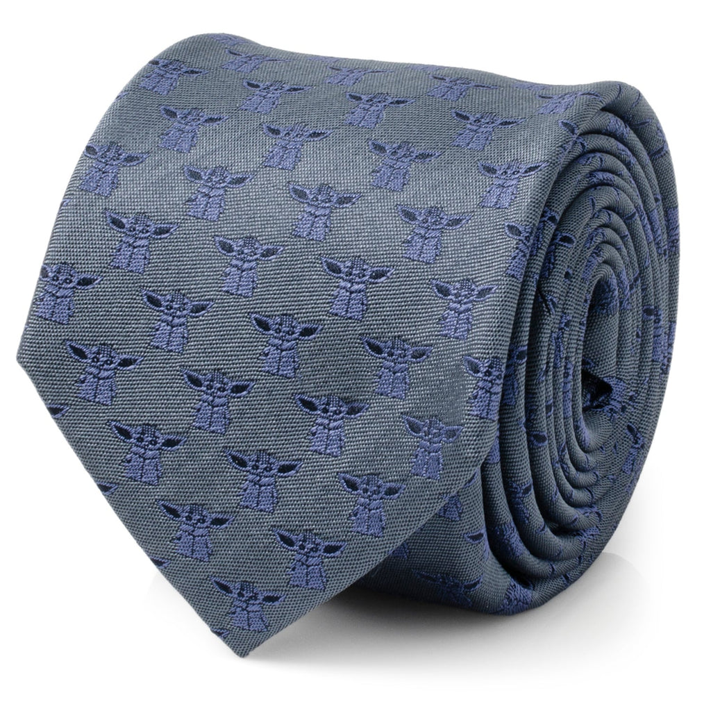 A blue silk necktie with a tonal pattern of Grogu from The Mandalorian, displayed on a mannequin and rolled up.