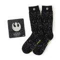 A gift set containing black crew socks with a white hyperspace pattern and a silver Rebel Alliance symbol lapel pin.