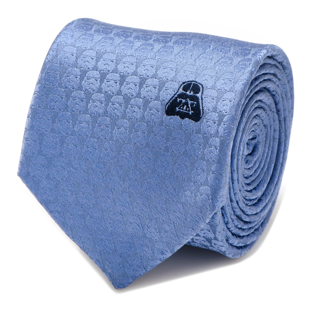 A blue silk necktie featuring a repeating tonal Stormtrooper helmet pattern and an embroidered black Darth Vader helmet.
