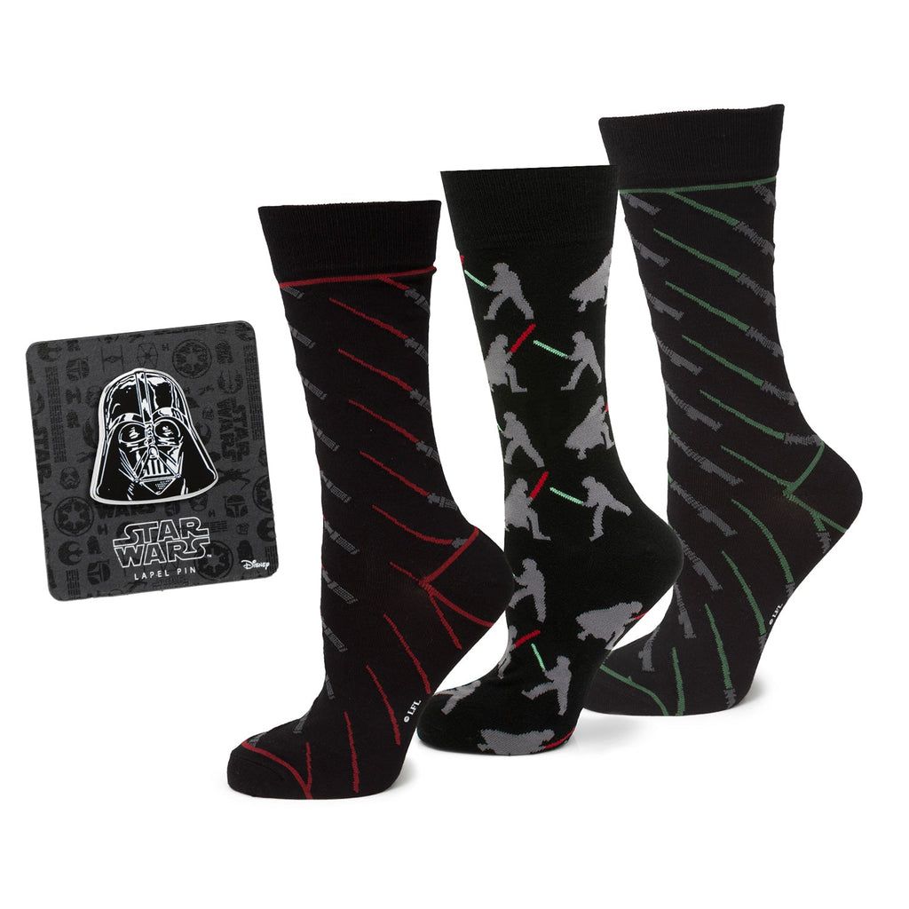 Three pairs of Star Wars themed black crew socks and a Darth Vader lapel pin on a display card.