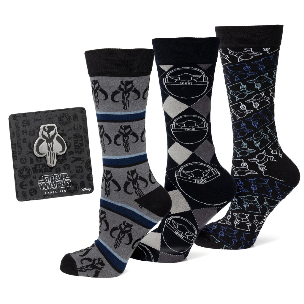 Three pairs of Star Wars Mandalorian dress socks including Mythosaur and Grogu designs next to a Mythosaur lapel pin.