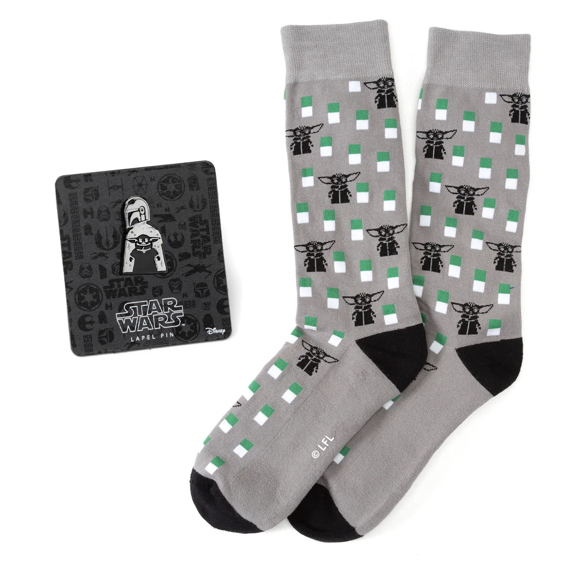 A pair of gray crew socks featuring a pattern of Grogu and a matching Star Wars The Mandalorian metal lapel pin.