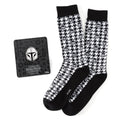 Black and white houndstooth pattern crew socks with Mandalorian helmet icons and a matching Star Wars lapel pin on display.