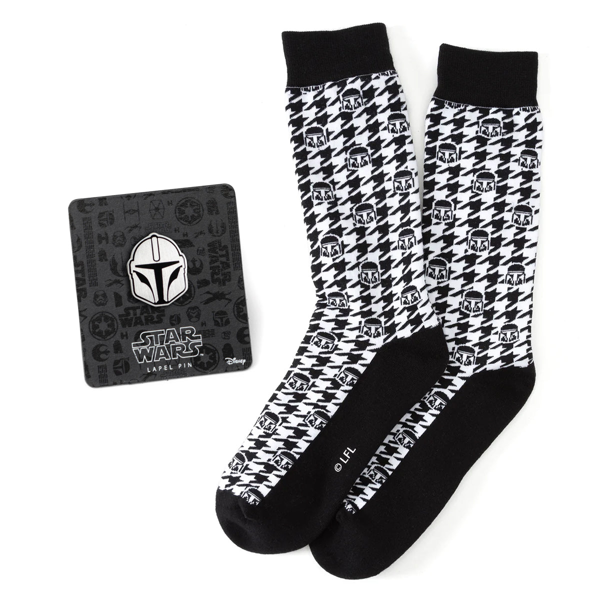 Black and white houndstooth pattern crew socks with Mandalorian helmet icons and a matching Star Wars lapel pin on display.