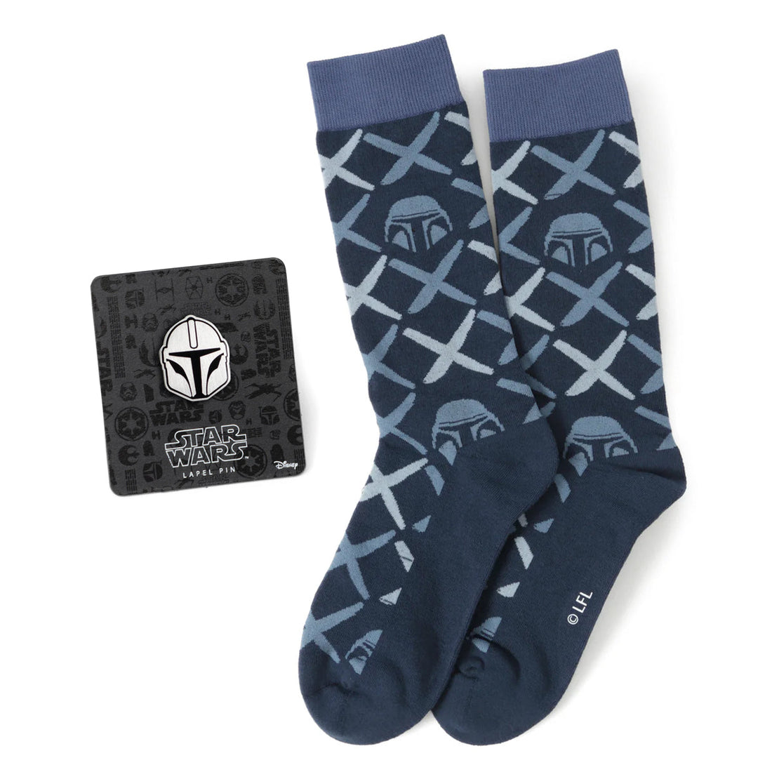 The Mandalorian navy dress socks with helmet pattern displayed next to a matching Mandalorian helmet lapel pin on a black Star Wars branded card.