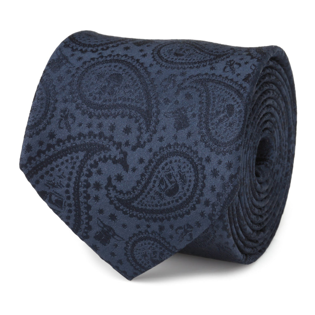 Close up of a navy blue silk necktie featuring a subtle Mandalorian and Grogu paisley pattern.