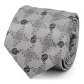 Close up of a gray silk blend necktie featuring a repeating Millennium Falcon pattern in Star Wars theme.
