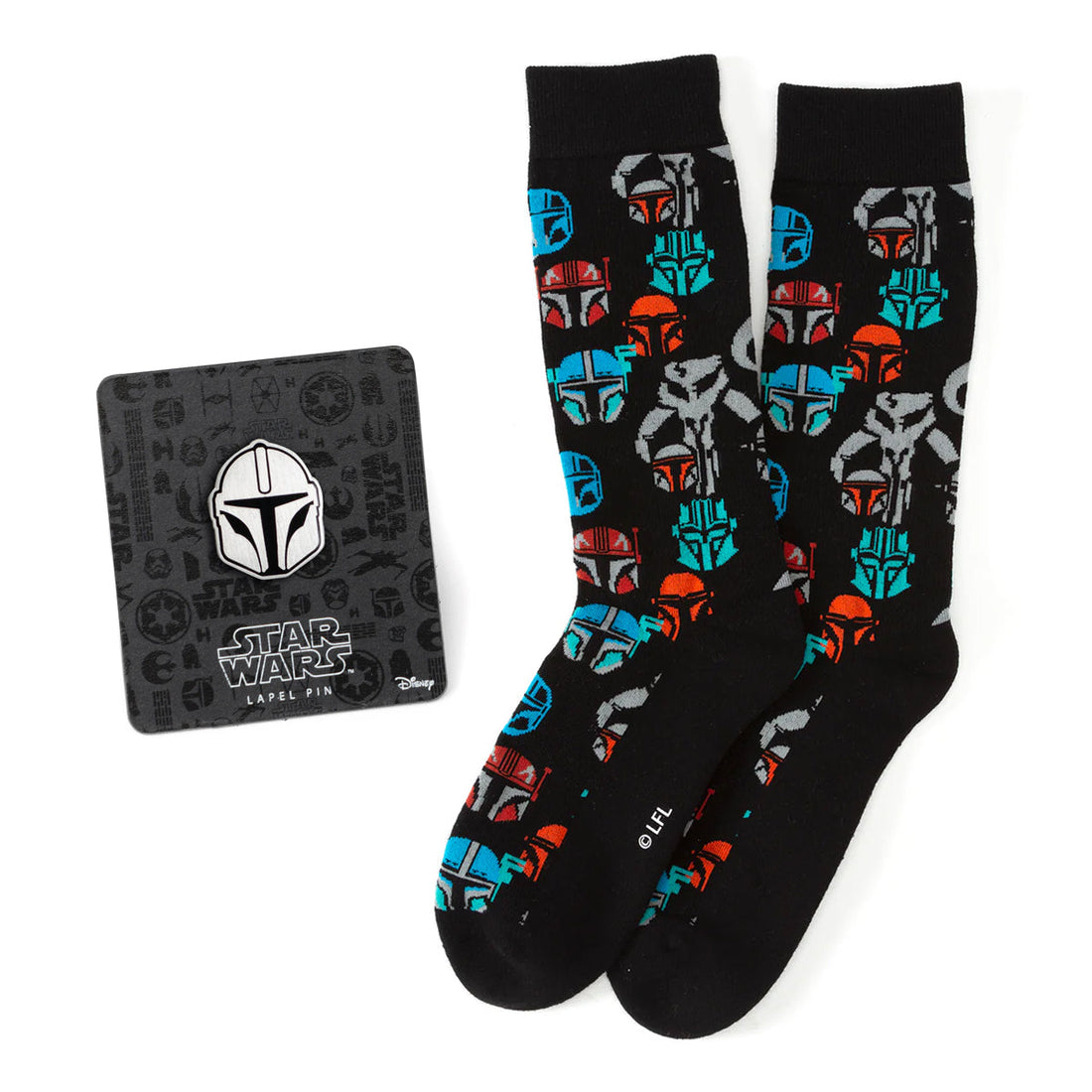 A pair of black crew socks with a colorful Mandalorian helmet pattern alongside a Star Wars Mandalorian helmet lapel pin on a display card.
