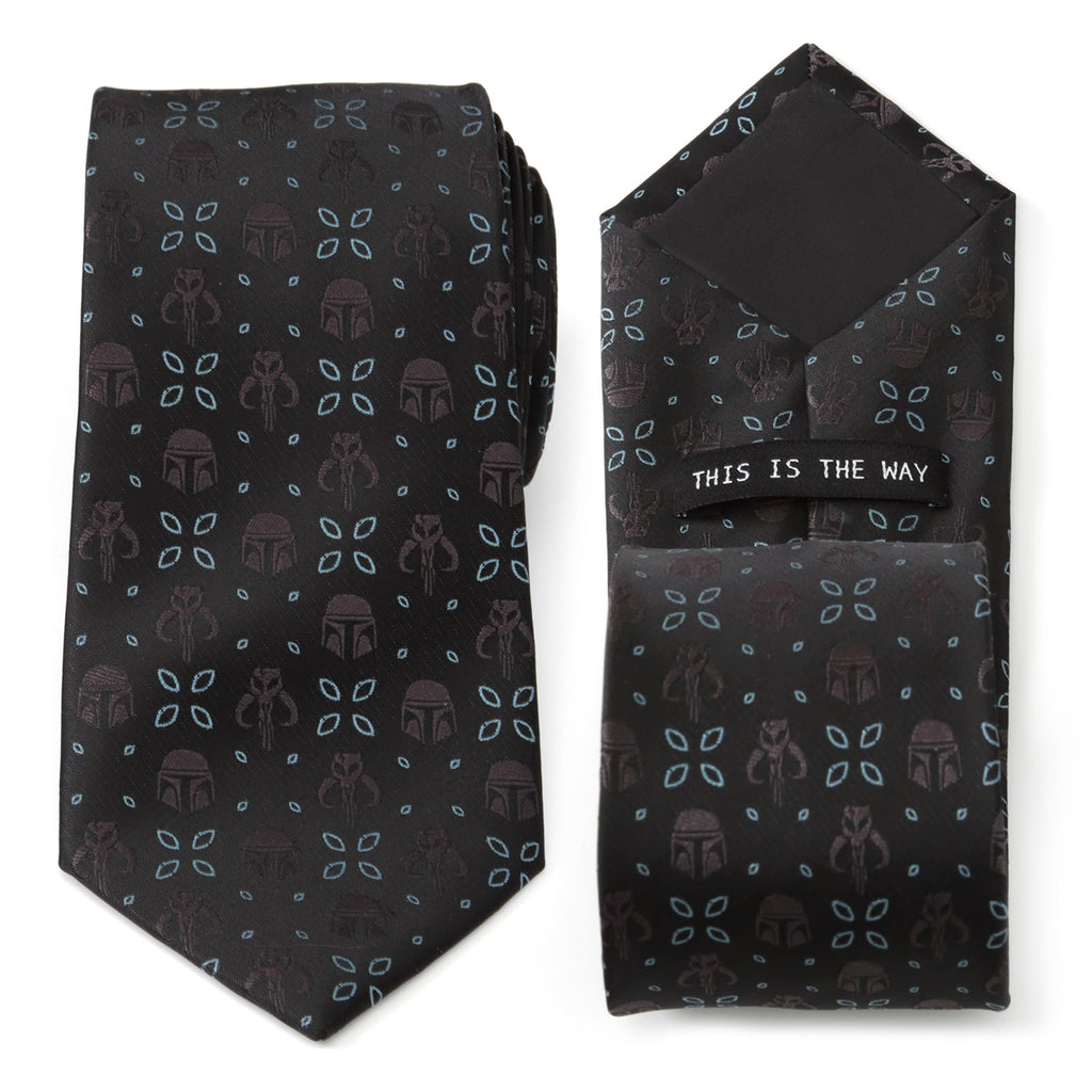 Close up of a black necktie with Mandalorian helmet and Mythosaur skull motifs in black with electric blue floral accents.