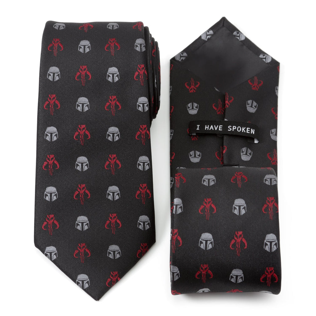 Close up of Star Wars Mandalorian necktie with red Mythosaur and silver helmet pattern on black fabric