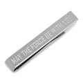 A close-up of a silver Star Wars tie bar engraved with the words May The Force Be With You