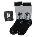 A gift set containing gray and black Star Wars R2-D2 themed crew socks and a matching R2-D2 lapel pin.