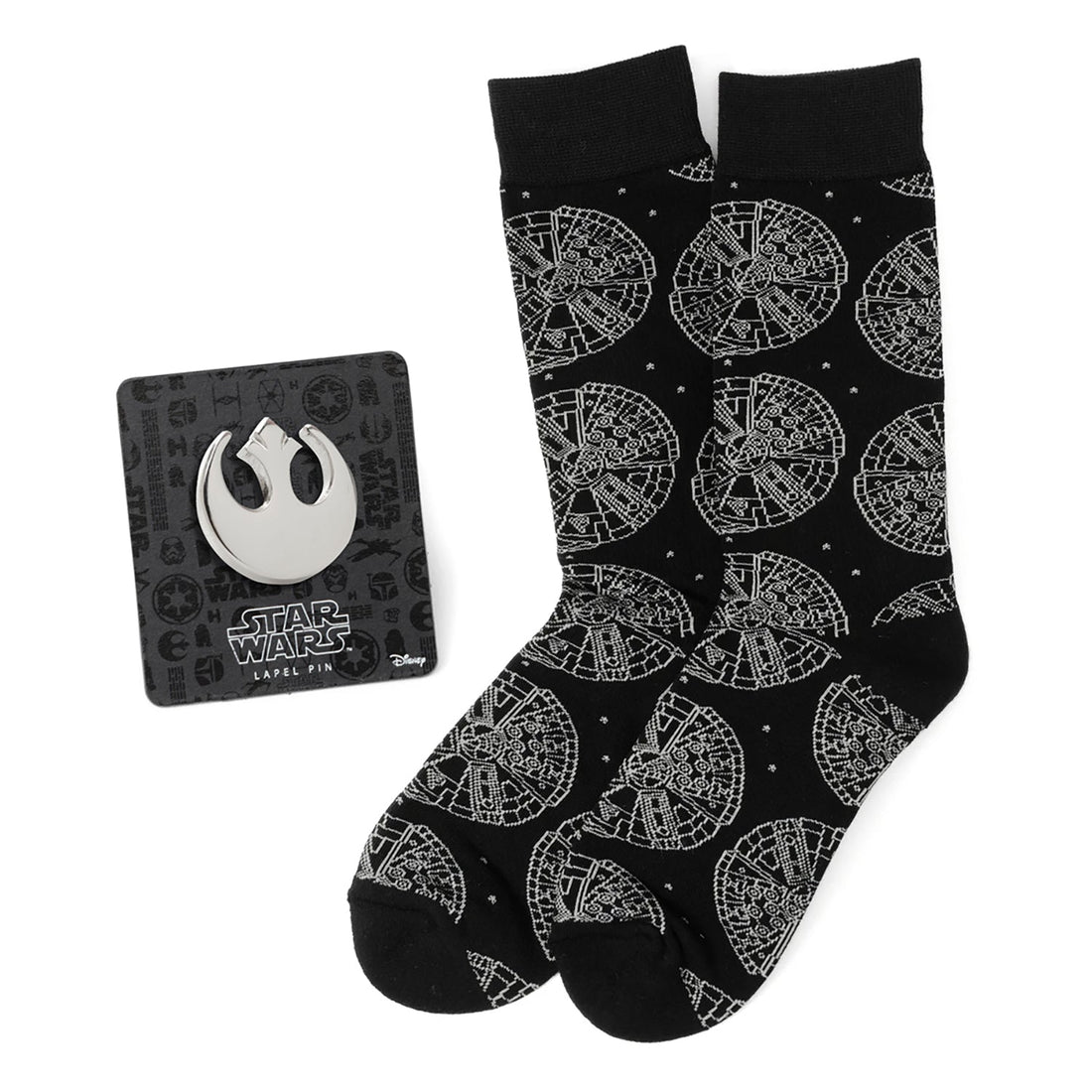 A black pair of Star Wars Millennium Falcon socks next to a Rebel Alliance metal lapel pin on its display card.