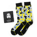 A pair of yellow, blue, and black camo Star Wars Stormtrooper crew socks with a matching white Stormtrooper helmet lapel pin.