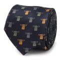 A navy blue silk necktie featuring a repeating pattern of Grogu from The Mandalorian in yellow, grey, and sage green.
