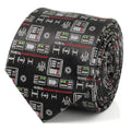 Close-up of a black silk necktie featuring a repeating pattern of Darth Vader chest plates, helmets, and TIE fighter icons.