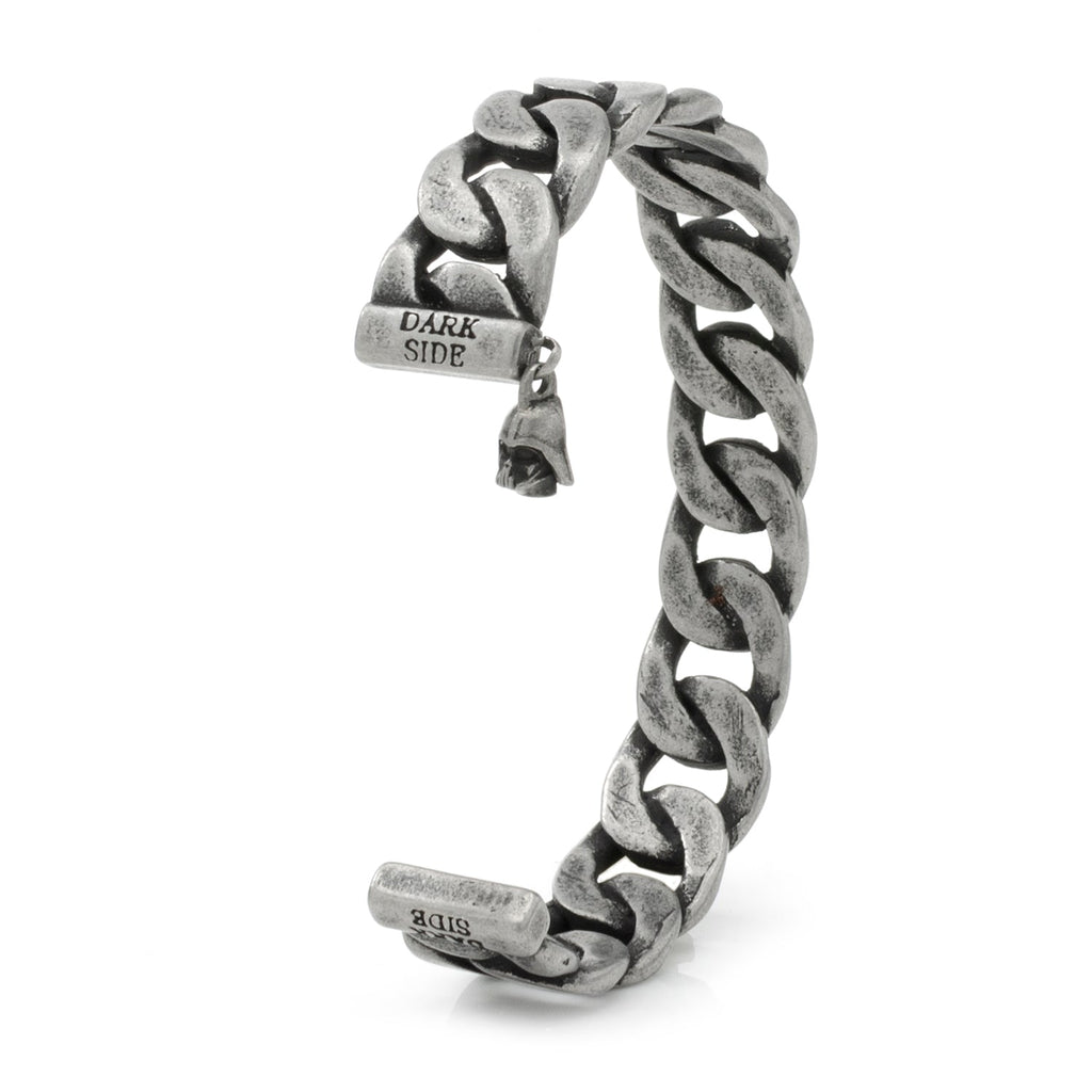 Close-up view of an antique silver-tone stainless steel chain link bracelet featuring a Darth Vader helmet charm and Dark Side engraving
