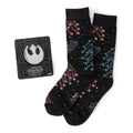 A pair of black Star Wars themed crew socks with an X-Wing and TIE fighter battle pattern next to a silver Rebel Alliance symbol lapel pin.