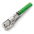 A silver and green Yoda lightsaber tie clip resting on a white surface and worn on a black tie.