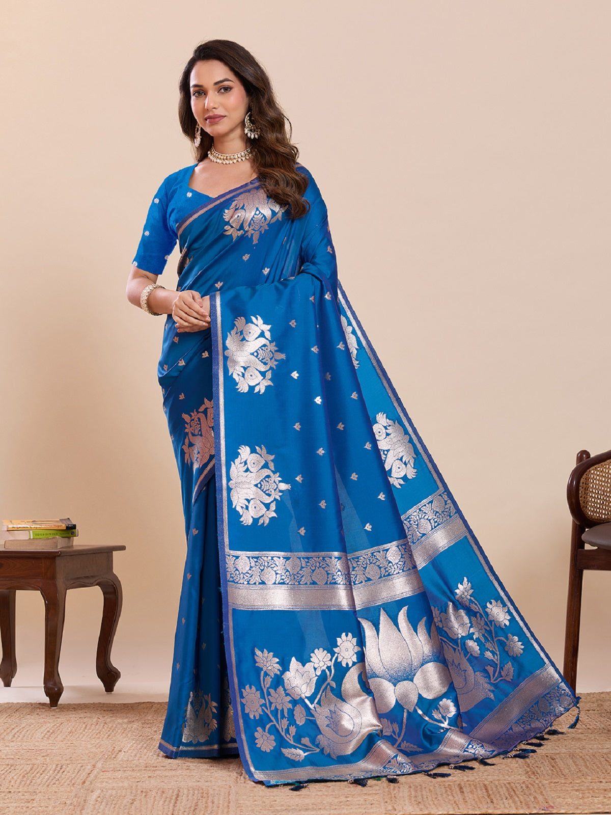 A beautiful blue Paithani silk wedding saree featuring intricate gold Jari weaving with a matching unstitched blouse piece.