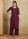 A stylish maroon printed cotton blend kurta paired with matching printed pants